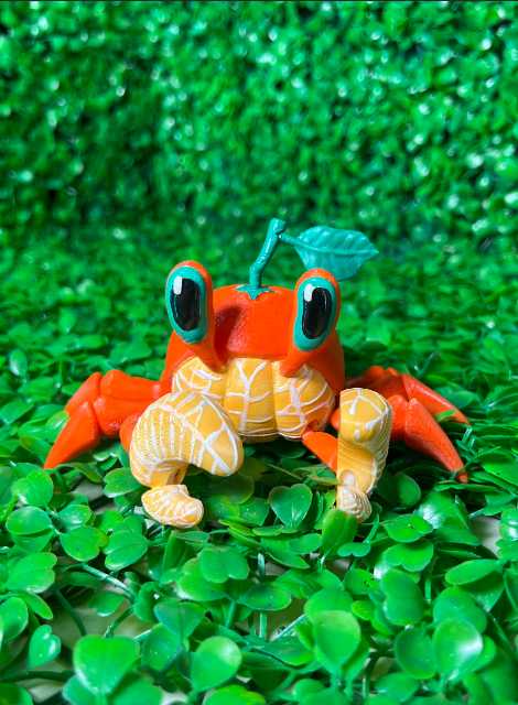 3D-printed Cute Orange Crab Flexi model by Whale 3D Studio, flexible and vibrant beginner 3D printing idea with movable joints.