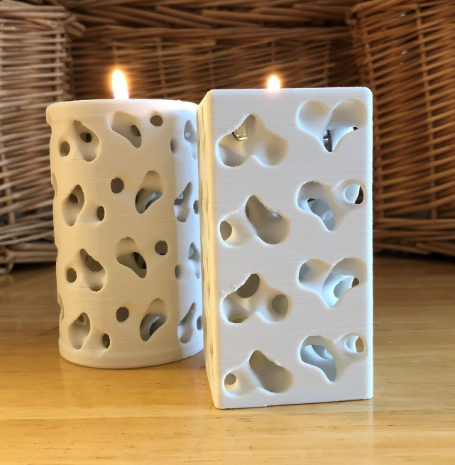 Two white, 3D-printed Heartstrings Tealight Holders with heart-shaped cutouts, casting romantic light patterns. A cozy 3D print for wife or girlfriend to create a warm, inviting ambiance at home.
