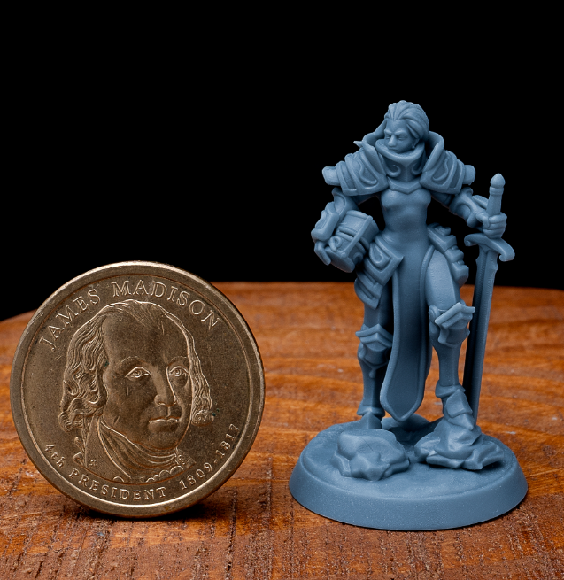 A dynamic 3D-printed miniature of a female knight, featuring detailed armor and a commanding pose.
