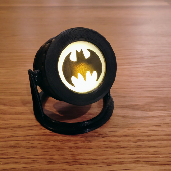 Small Batman signal tea light projector with the iconic bat symbol, a perfect print for superhero fans and unique room decor.