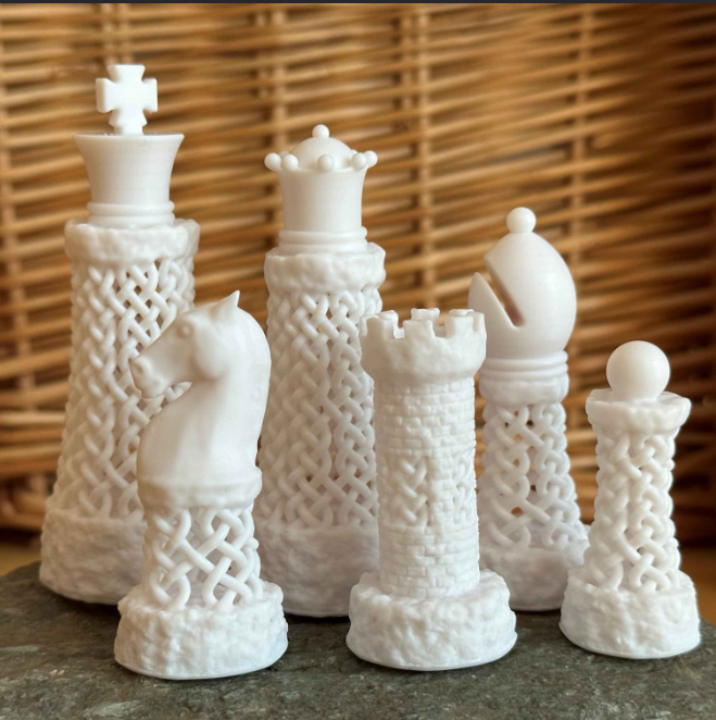 Intricately designed white chess pieces with Celtic patterns, including a knight, rook, and bishop, ideal for those who enjoy unique and detailed 3D prints.