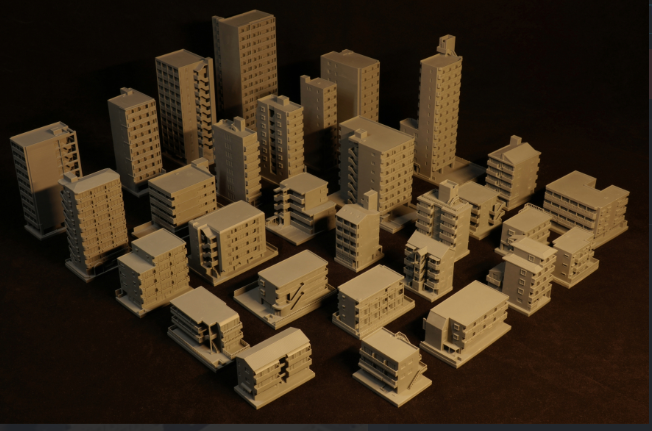 A collection of 3D-printed miniature buildings, showcasing various architectural styles and heights, ideal for model cityscapes or tabletop games. These detailed structures provide a customizable and creative way to bring urban environments to life.