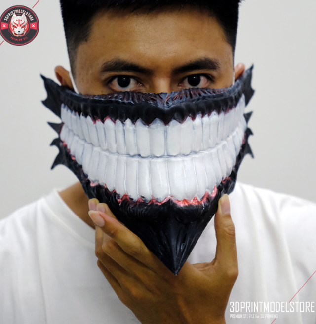 A striking 3D-printed mask featuring a sinister grin with sharp teeth and intricate details, worn as a bold costume accessory. This creative and customizable design is a standout choice for 'things to 3D print and sell' for cosplay or themed events.