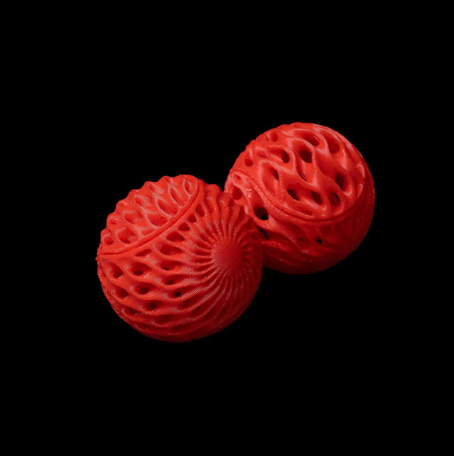 Two bright red 3D-printed cat toys featuring intricate lattice designs that create a lightweight and playful texture. These durable and visually appealing toys are perfect for keeping cats entertained.