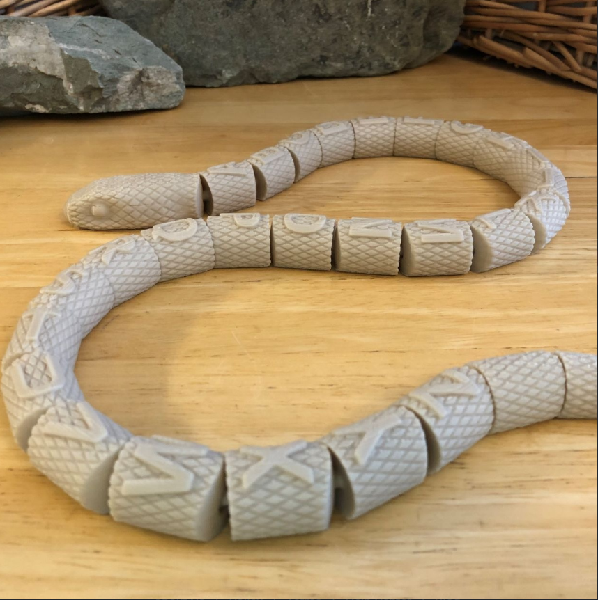 A unique articulated 3d snake with alphabets.